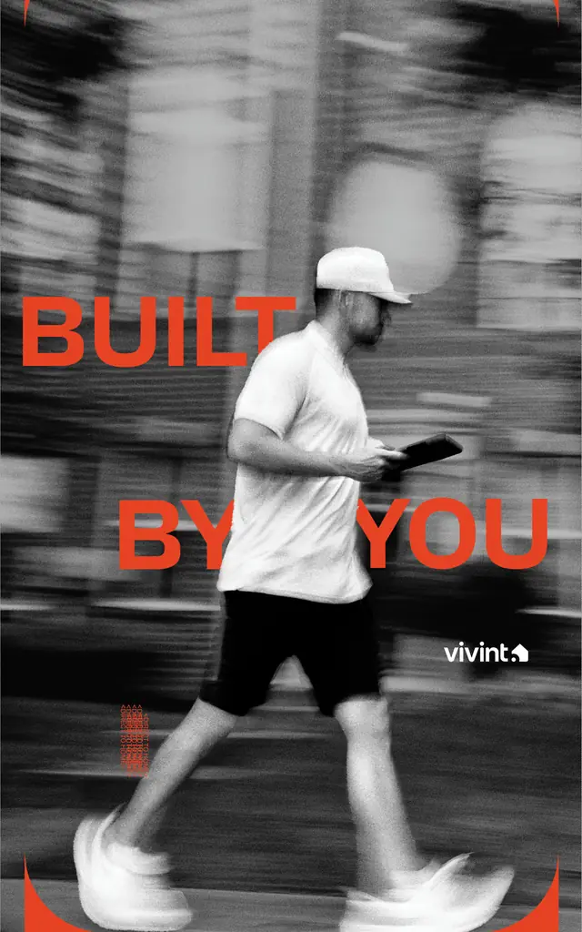 Rep walking a neighborhood with a tablet under the line Built By You